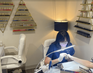 nail technician working in the spa that is for sale in davenport iowa